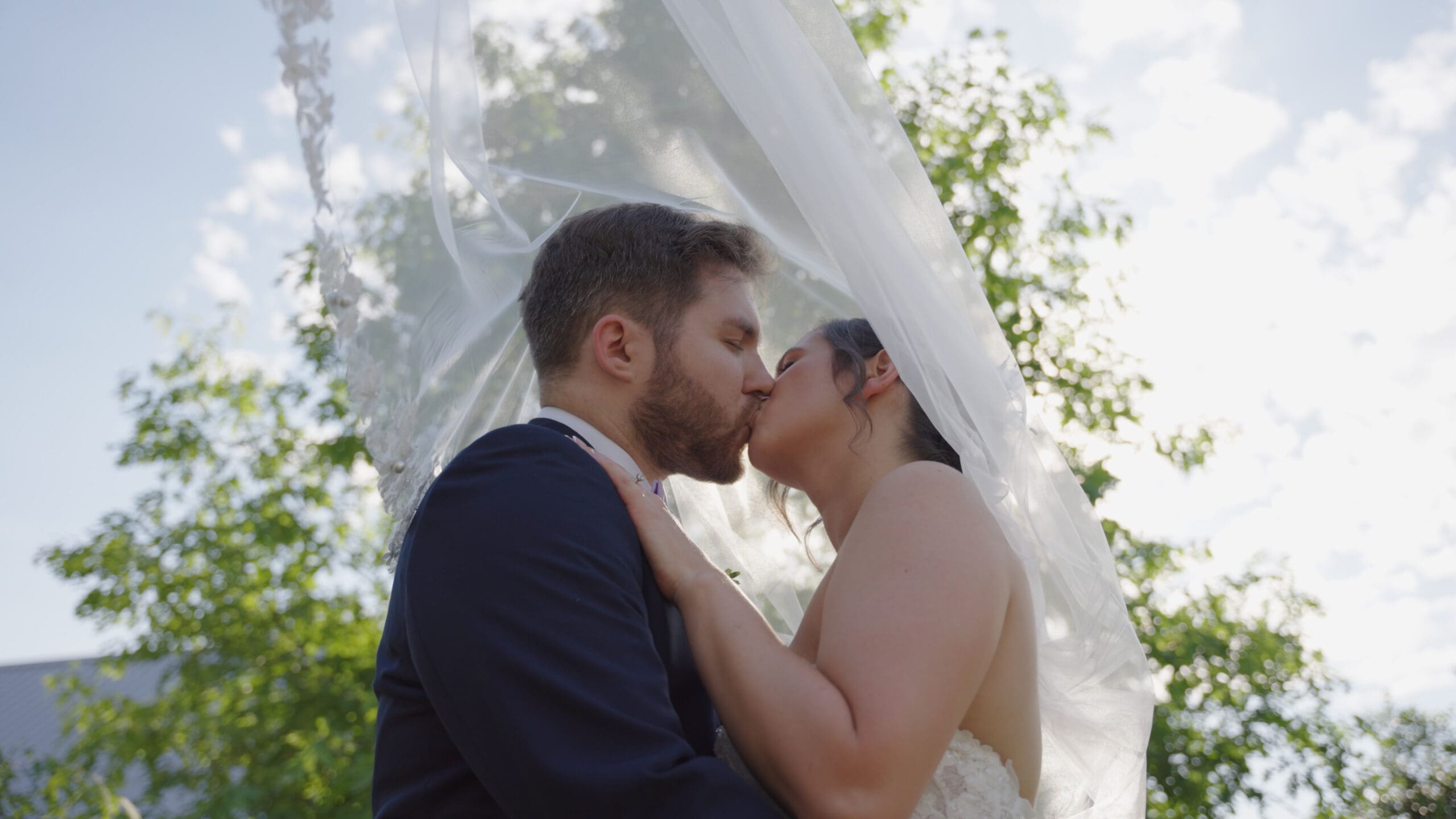 Beautiful Cinematic Film shot Newlyweds under veil with sunset